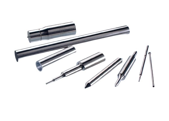 Charging pins alongside production tooling